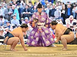 Sumo wrestlers in the dohyo ring during a bout
